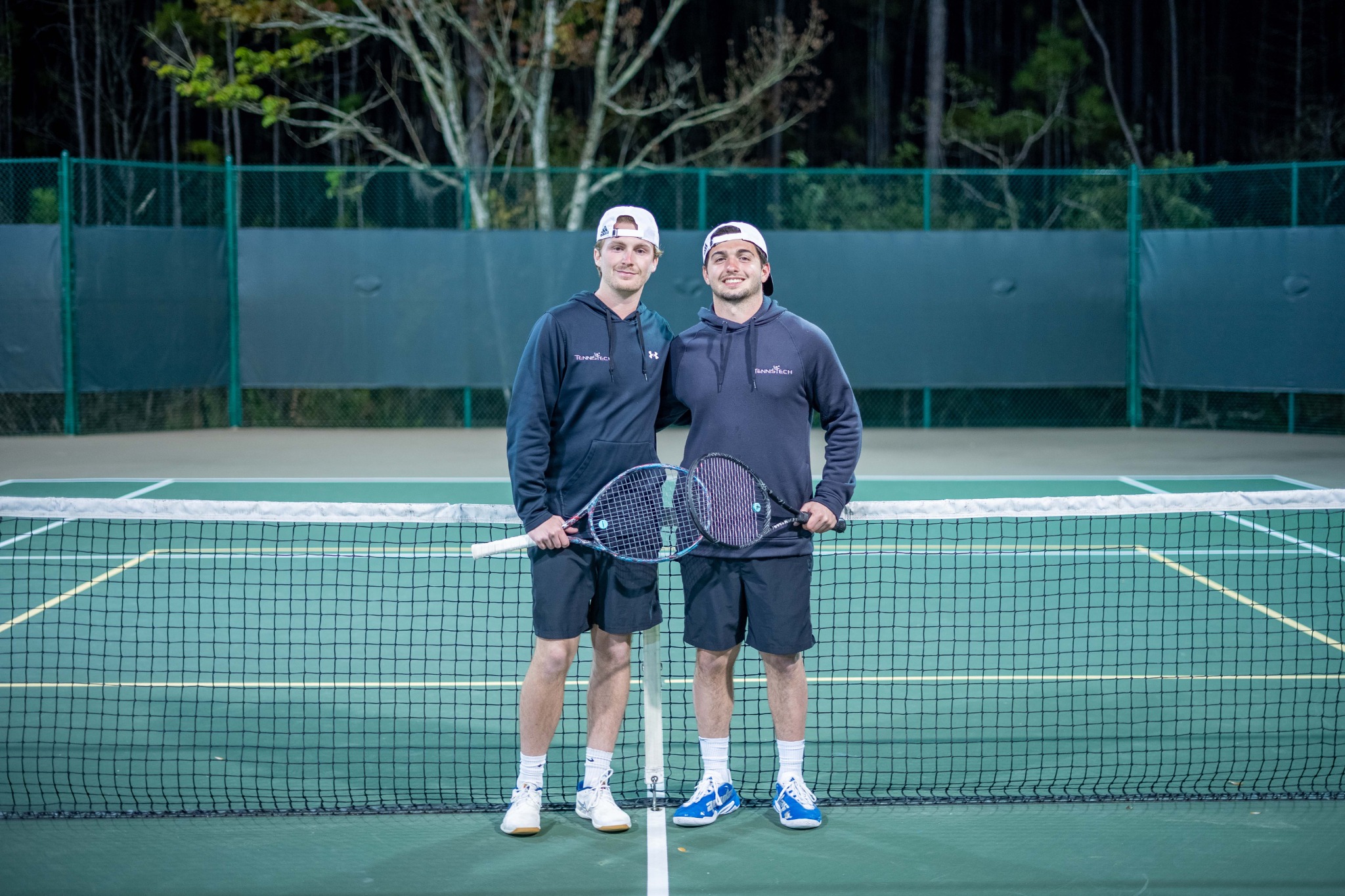 Tom and Tyler standing together on a tennis court